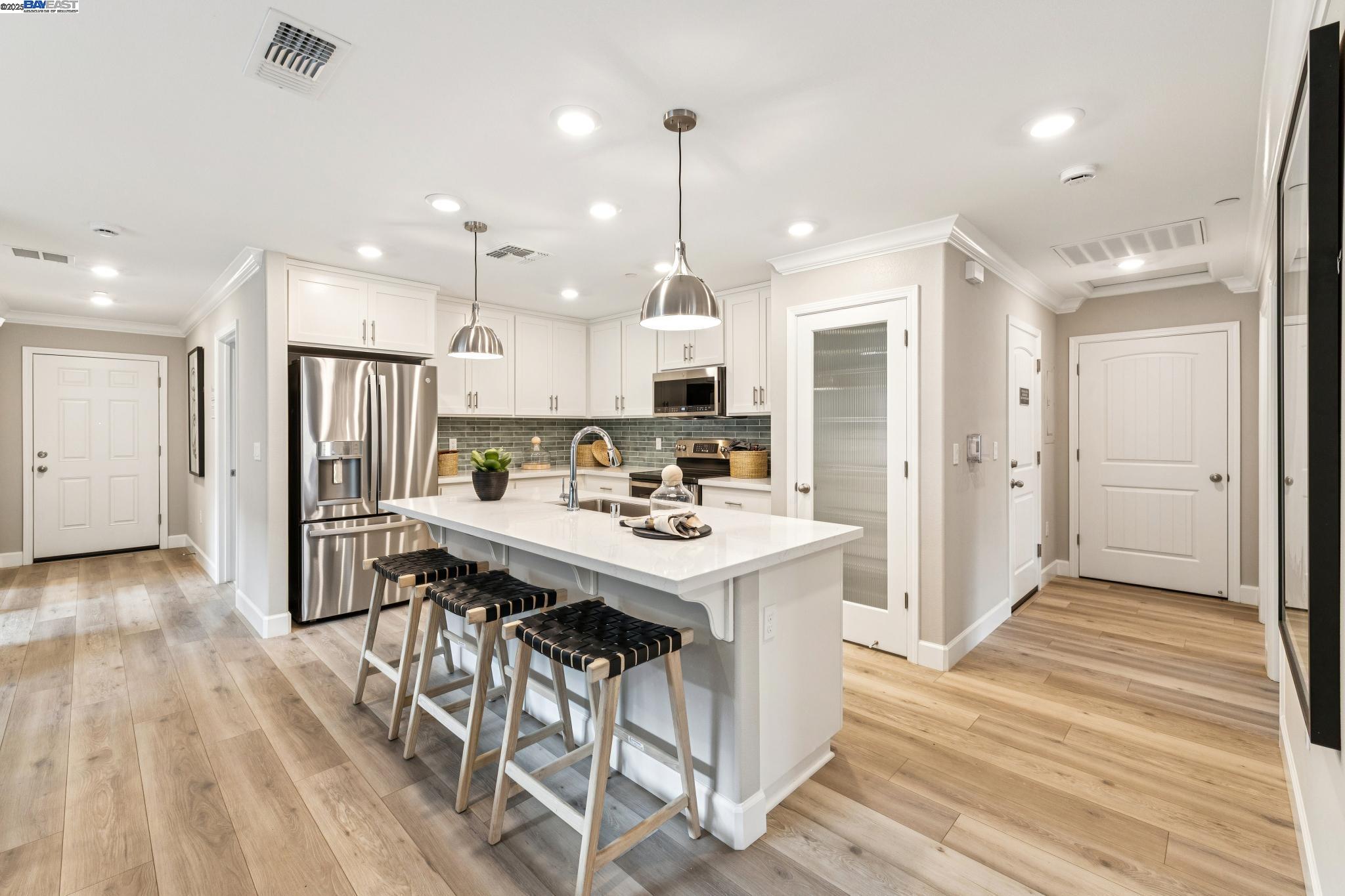 2652 Wesley Way Chico, CA 95973 - Photo 17 of 45 a kitchen with stainless steel appliances a dining table chairs stove refrigerator and cabinets