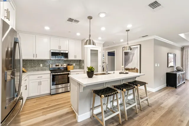 a kitchen with a stove microwave and cabinets