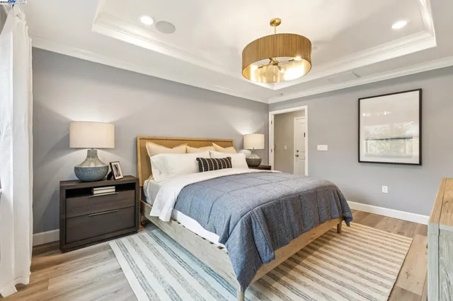 a bedroom with a bed and a chandelier