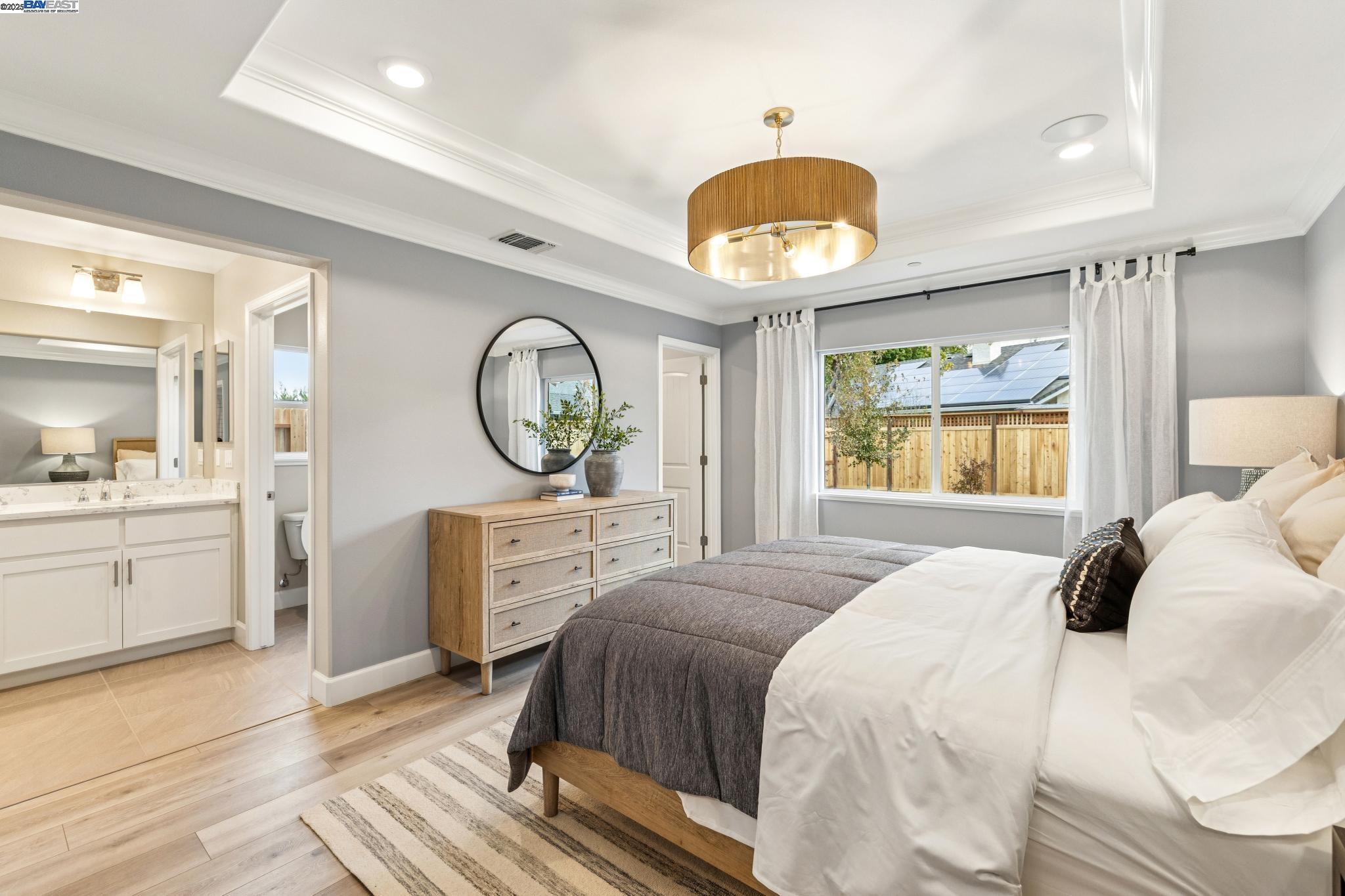 2652 Wesley Way Chico, CA 95973 - Photo 27 of 45 a bedroom with a bed and a chandelier