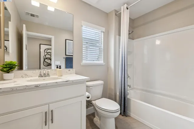 a bedroom with a bed dresser and a window