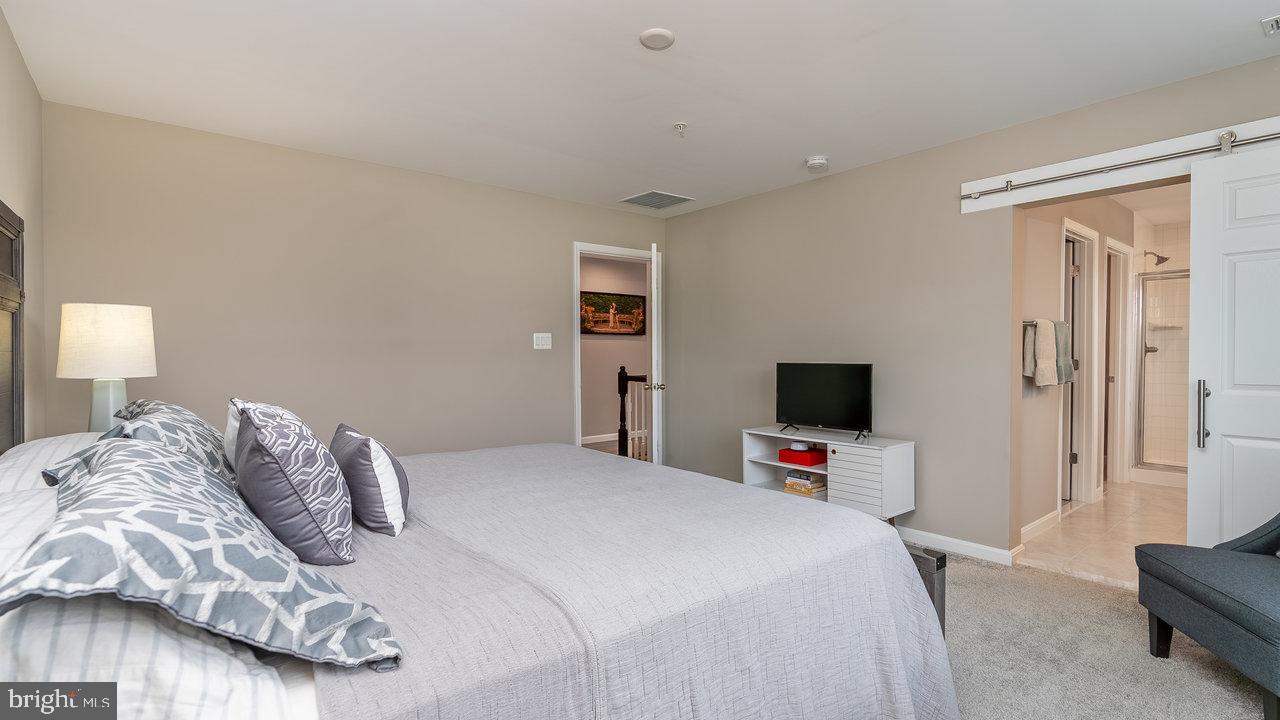 12610 Rosencrans Dr. Hagerstown, MD 21740 - Photo 27 of 49 a bedroom with a bed and a flat tv screen on a dresser