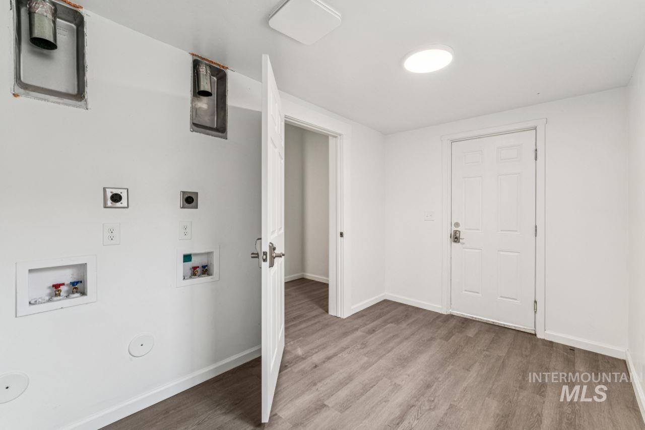 911 2nd Street South Nampa, ID 83651 - Photo 11 of 50 Laundry room featuring hookup for a washing machine, electric dryer hookup, and light wood-style floors