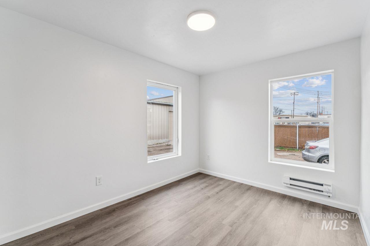 911 2nd Street South Nampa, ID 83651 - Photo 16 of 50 Spare room with a baseboard radiator and light wood-type flooring