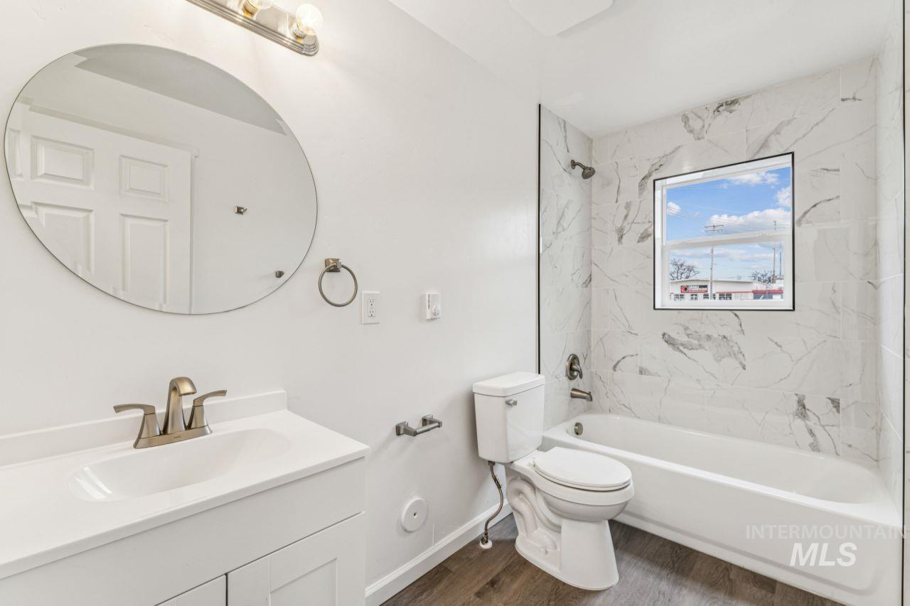 911 2nd Street South Nampa, ID 83651 - Photo 18 of 50 Bathroom featuring vanity, shower / tub combination, and dark wood-type flooring
