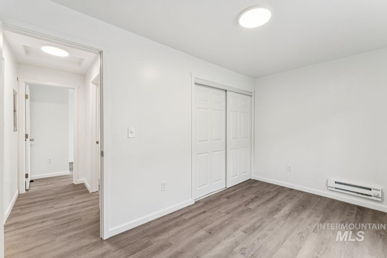 911 2nd Street South Nampa, ID 83651 - Photo 19 of 50 Unfurnished bedroom with light wood-type flooring, baseboard heating, and a closet