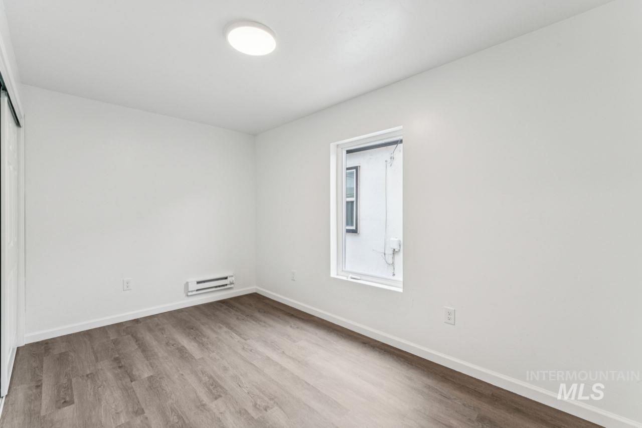 911 2nd Street South Nampa, ID 83651 - Photo 20 of 50 Unfurnished room with light wood-type flooring and a baseboard radiator