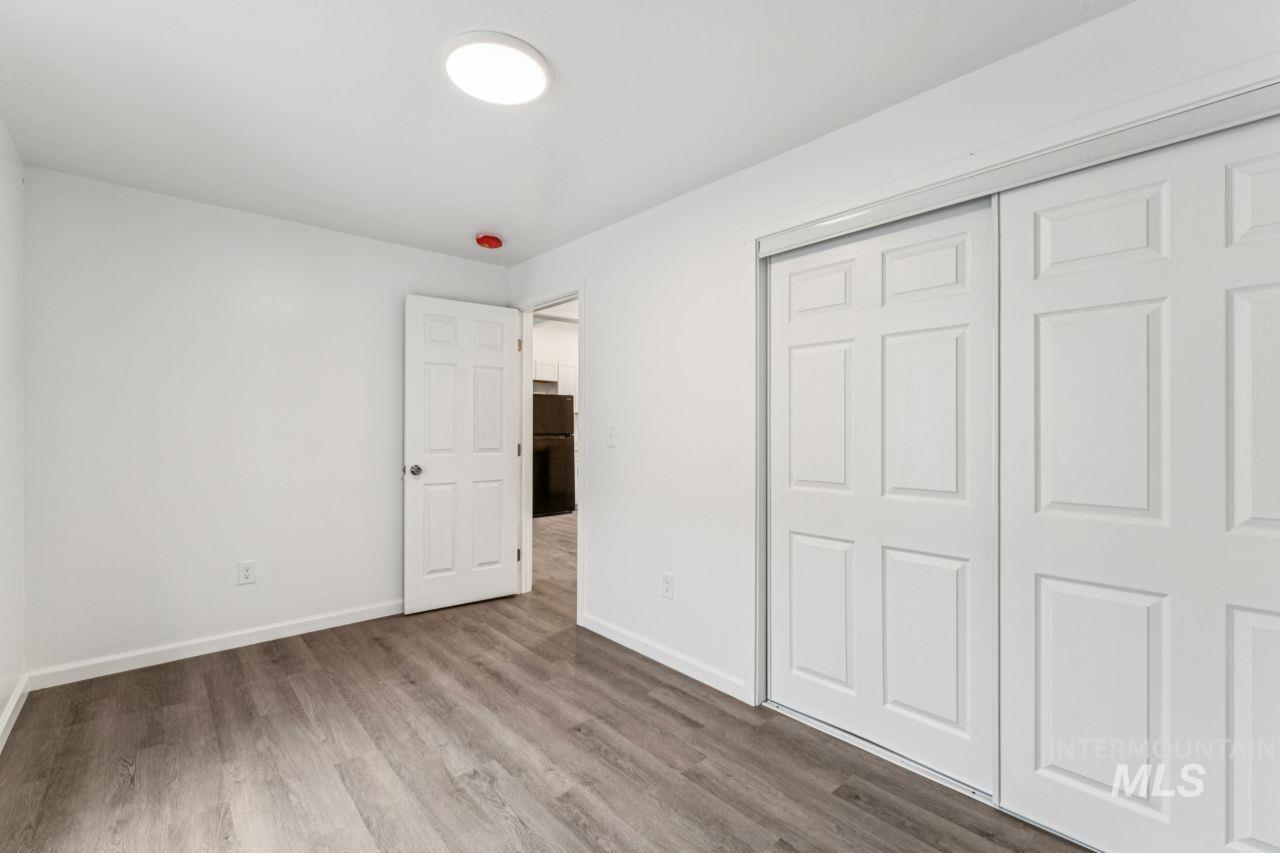 911 2nd Street South Nampa, ID 83651 - Photo 21 of 50 Unfurnished bedroom featuring wood finished floors, freestanding refrigerator, and a closet