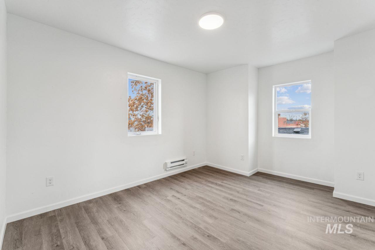 911 2nd Street South Nampa, ID 83651 - Photo 28 of 50 Spare room featuring light wood-style floors and a baseboard heating unit