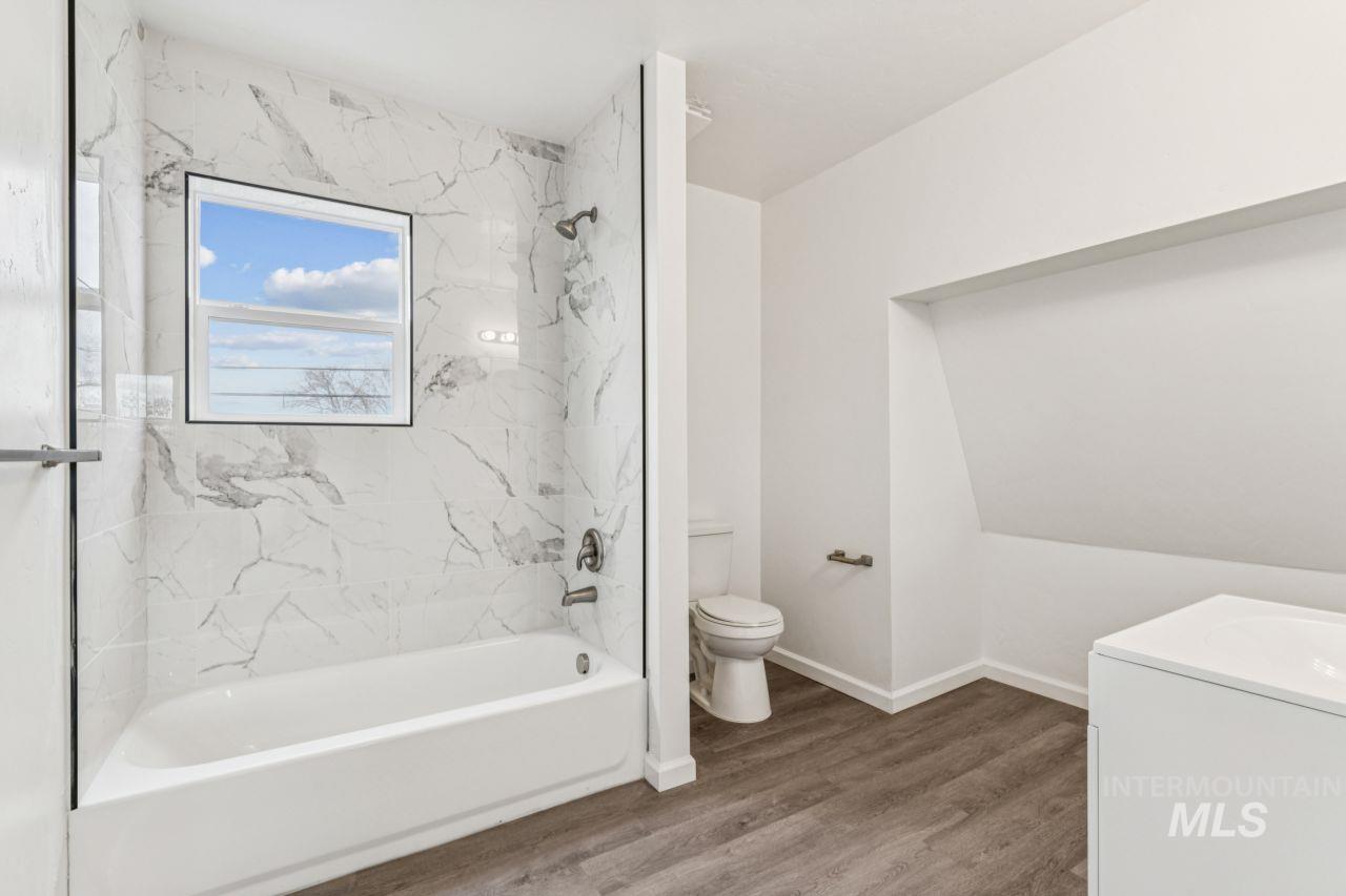 911 2nd Street South Nampa, ID 83651 - Photo 30 of 50 Full bathroom featuring shower / washtub combination, vanity, and wood finished floors