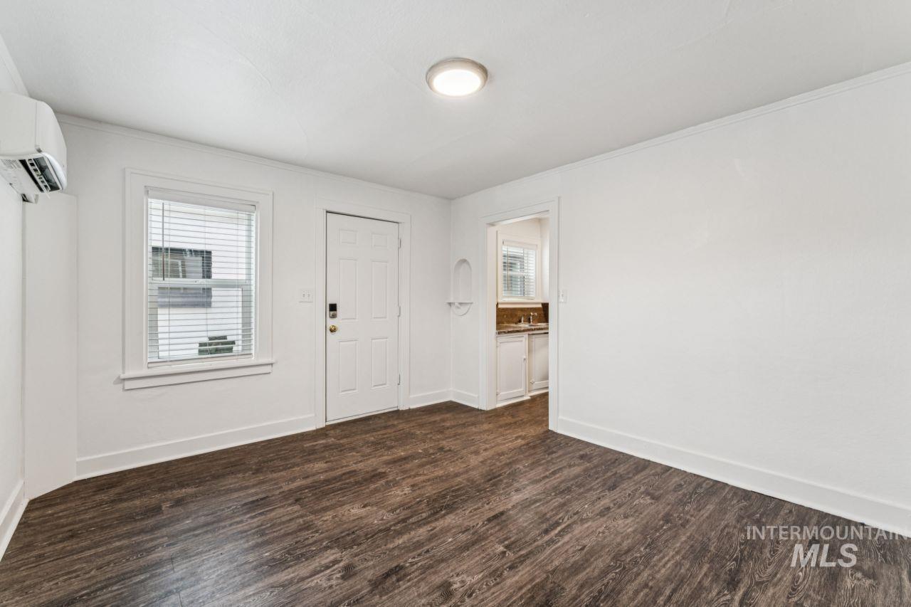 911 2nd Street South Nampa, ID 83651 - Photo 34 of 50 Entryway featuring healthy amount of natural light, dark wood-style flooring, a wall mounted air conditioner, and ornamental molding