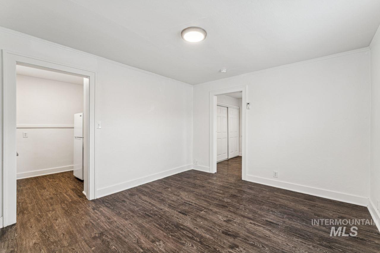 911 2nd Street South Nampa, ID 83651 - Photo 36 of 50 Unfurnished room featuring dark wood-style floors and crown molding