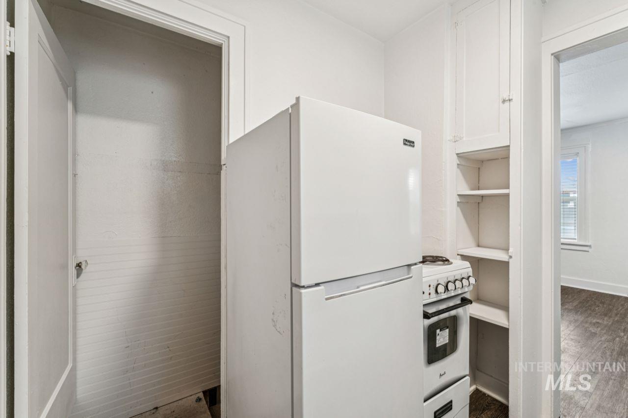 911 2nd Street South Nampa, ID 83651 - Photo 38 of 50 Kitchen featuring white appliances, white cabinets, and wood finished floors
