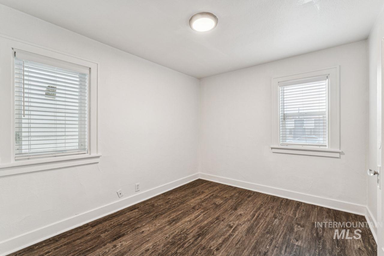 911 2nd Street South Nampa, ID 83651 - Photo 41 of 50 Unfurnished room featuring dark wood-style floors and baseboards
