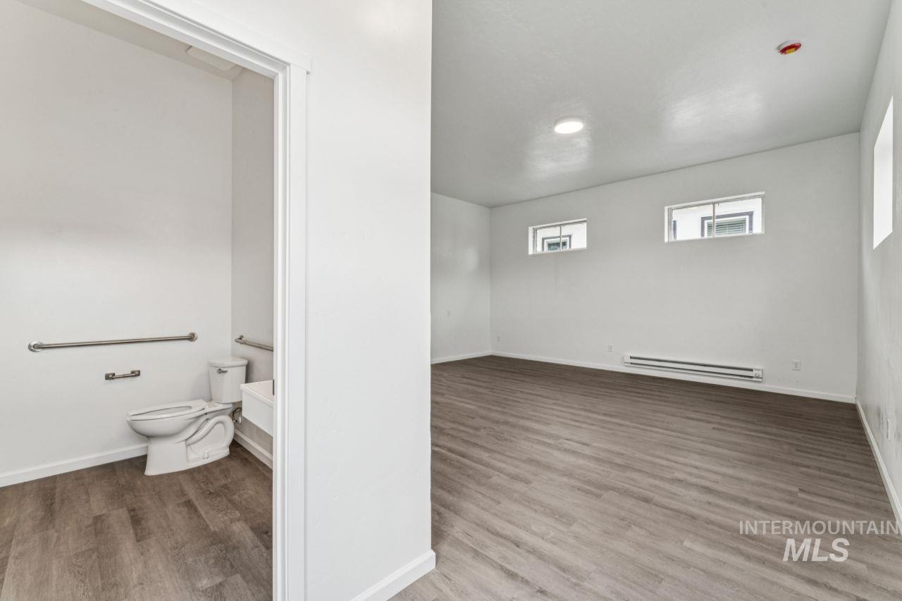 911 2nd Street South Nampa, ID 83651 - Photo 8 of 50 Bathroom with light wood-style flooring and a baseboard heating unit