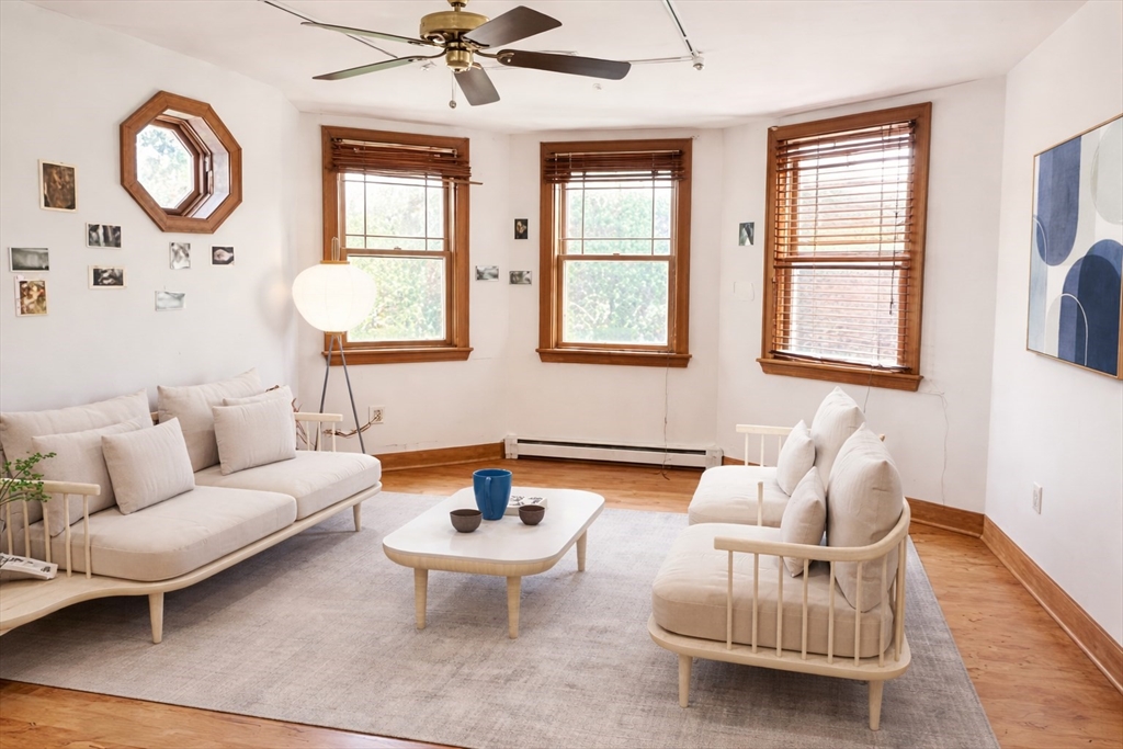 53 Hillside Street, Unit 1 Boston, MA 02120 - Photo 1 of 10 a living room with furniture a window and a chandelier