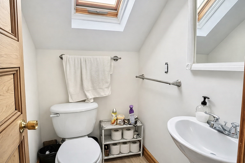 53 Hillside Street, Unit 1 Boston, MA 02120 - Photo 10 of 10 a bathroom with a toilet sink and mirror