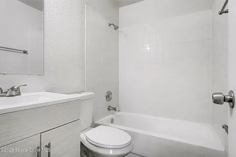 a bathroom with a sink a toilet and a bathtub