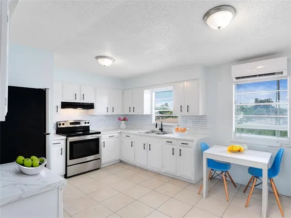 a kitchen with a sink cabinets and wooden floor