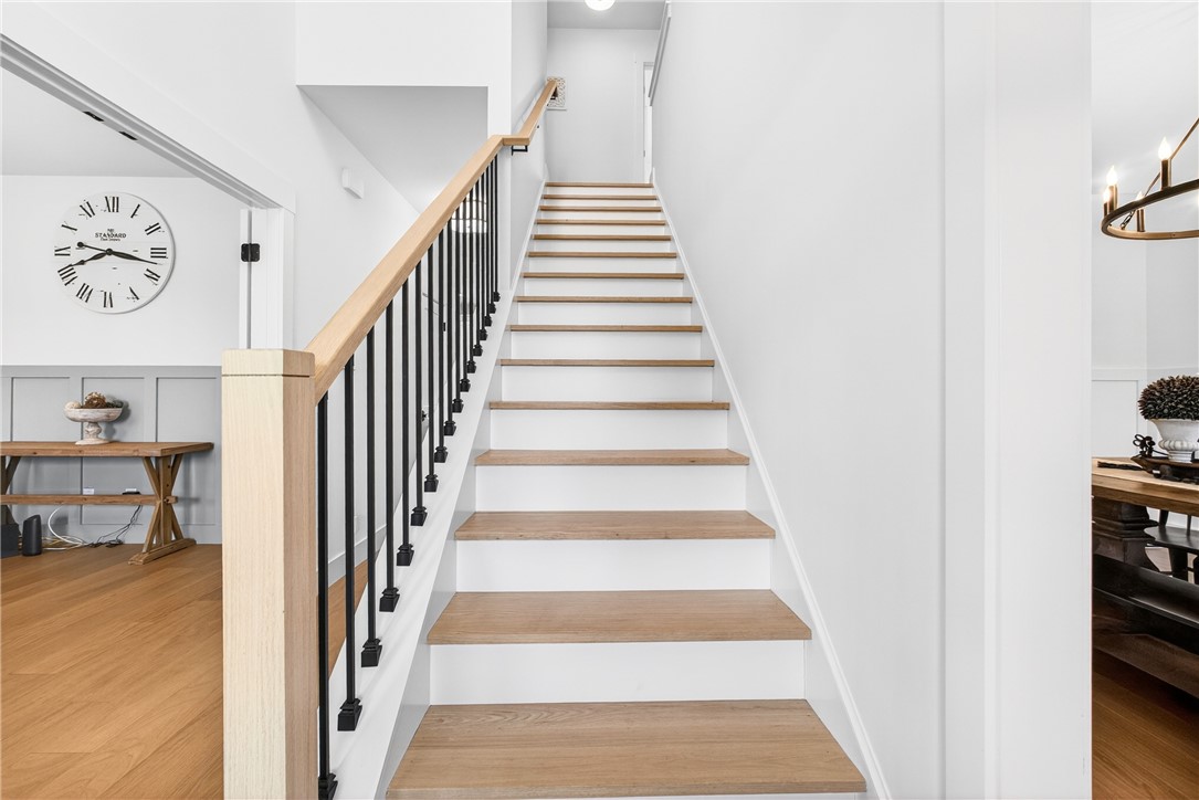 5016 Copeland Road Belton, SC 29627 - Photo 24 of 45 Elegant hardwood staircase with sleek black iron balusters leads to the upper level.