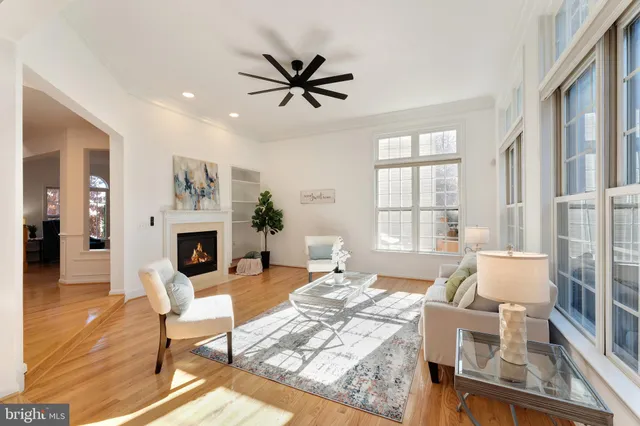 a living room with furniture a fireplace and a table