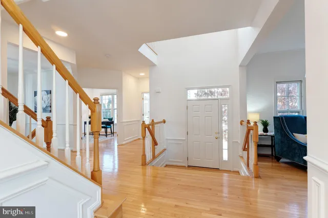 a view of a living room with wooden floor and stairs