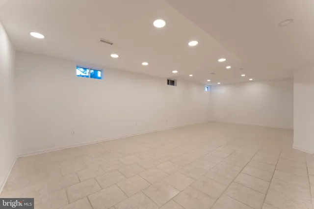 a view of a patio with couple of couch in front of building