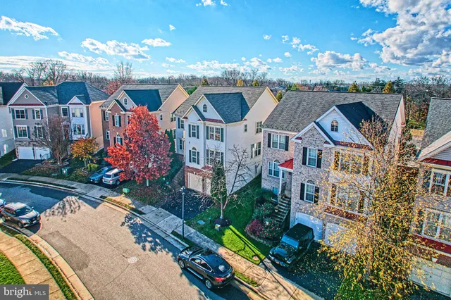 an aerial view of lake and residential houses with outdoor space
