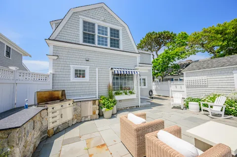 a front view of a house with outdoor seating