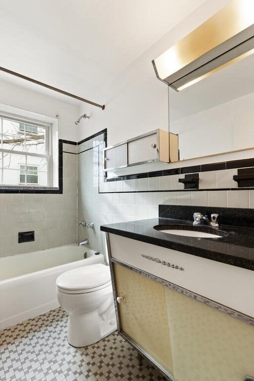 4 Menotomy Road, Unit 5 Arlington, MA 02476 - Photo 11 of 13 a bathroom with a sink a toilet and a bathtub