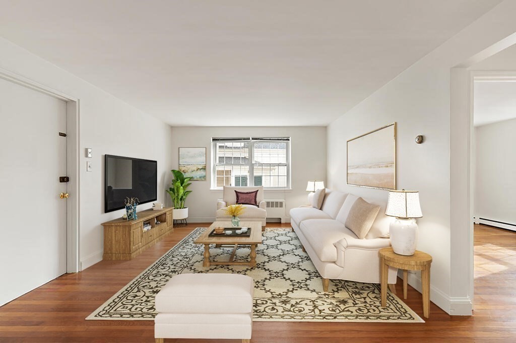 4 Menotomy Road, Unit 5 Arlington, MA 02476 - Photo 3 of 13 a living room with furniture wooden floor and a flat screen tv