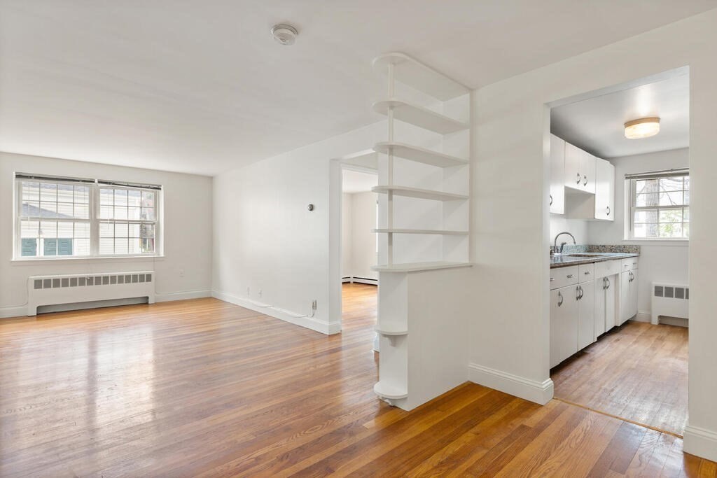 4 Menotomy Road, Unit 5 Arlington, MA 02476 - Photo 7 of 13 a view of empty room with wooden floor and fan