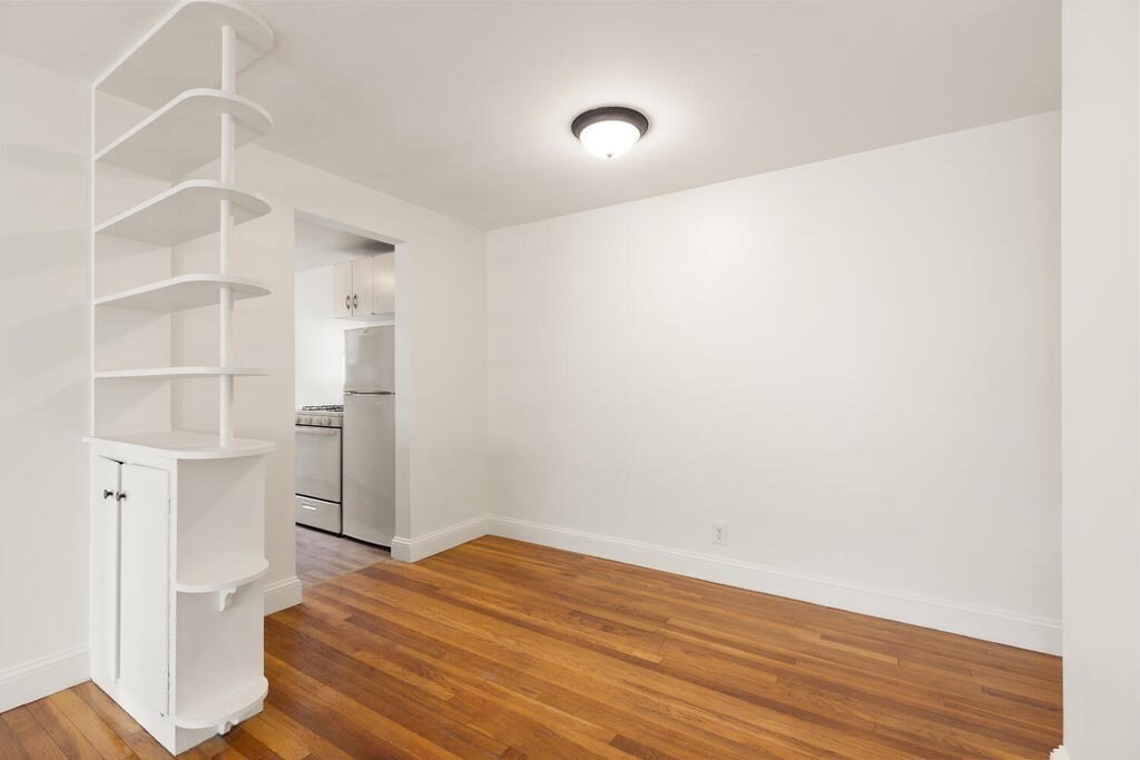 4 Menotomy Road, Unit 5 Arlington, MA 02476 - Photo 9 of 13 a view of empty room with wooden floor