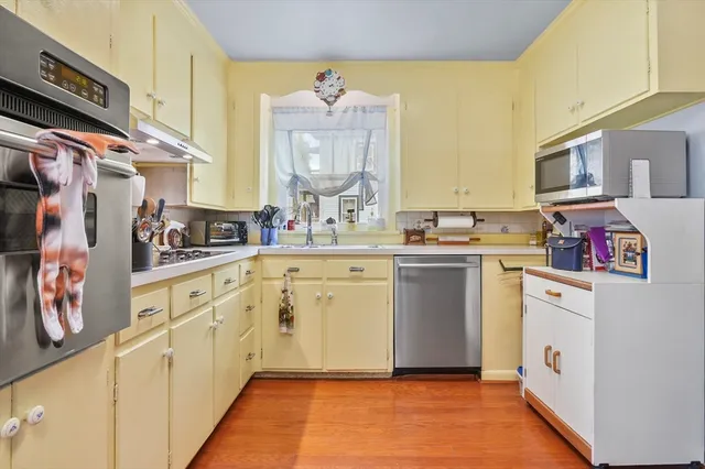 a view of kitchen with furniture and a refrigerator