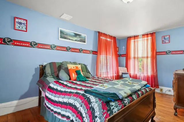 a bedroom with two beds and a flat screen tv