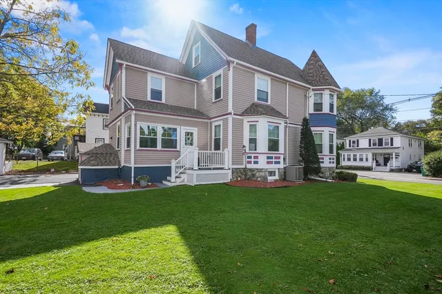a view of a house with a yard and sitting area