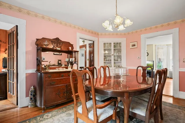 a view of a dining room with furniture and chandelier
