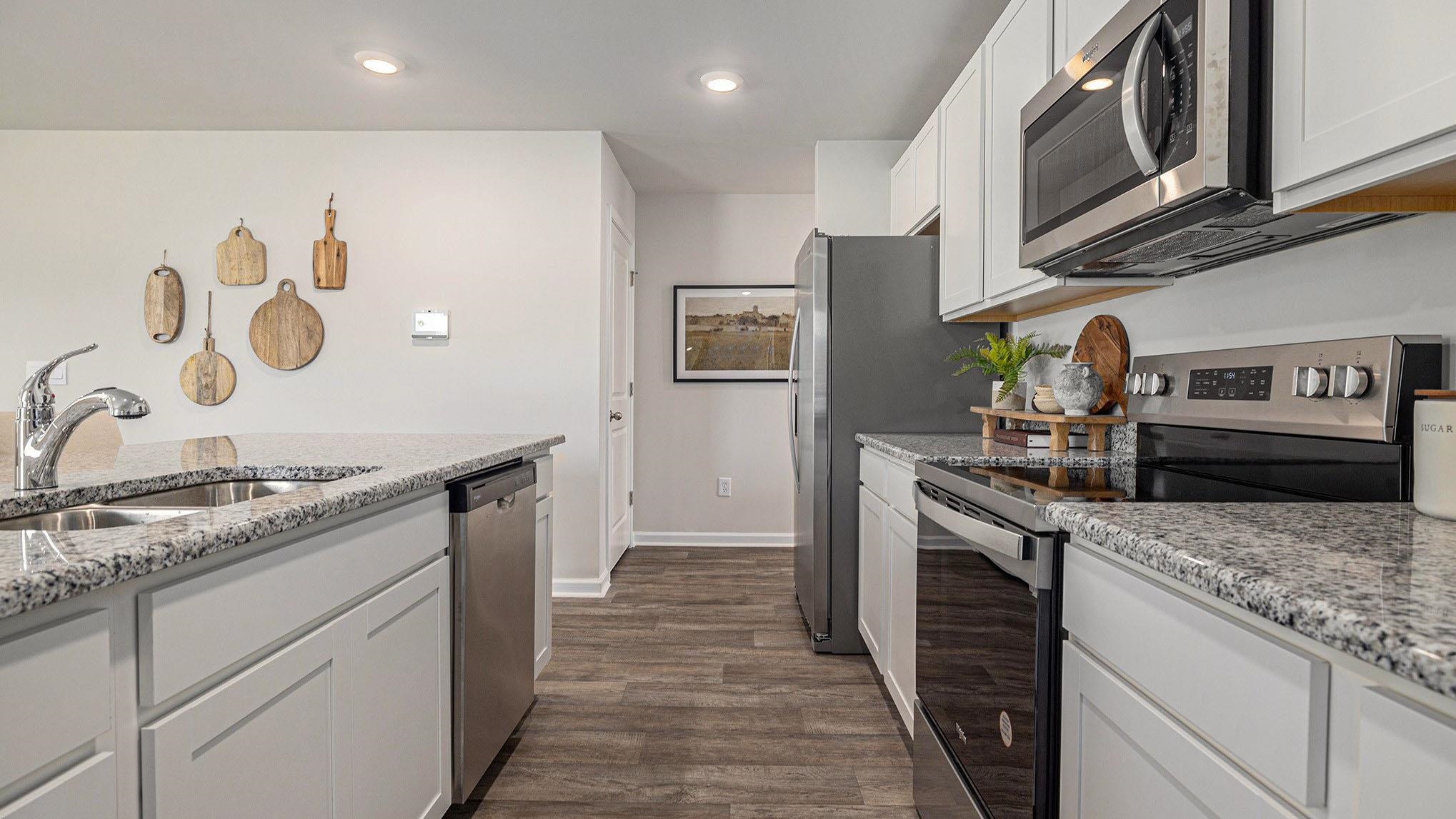 242 Bald Cypress Way Conway, SC 29526 - Photo 10 of 23 Kitchen with stainless steel appliances, white cabinetry, light stone counters, recessed lighting, and dark wood-style floors