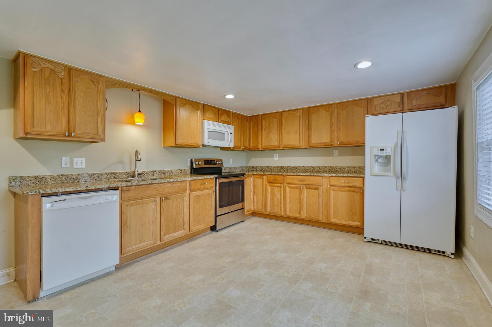 1080 Russell Road Berryville, VA 22611 - Photo 11 of 31 a kitchen with granite countertop a sink stainless steel appliances and cabinets