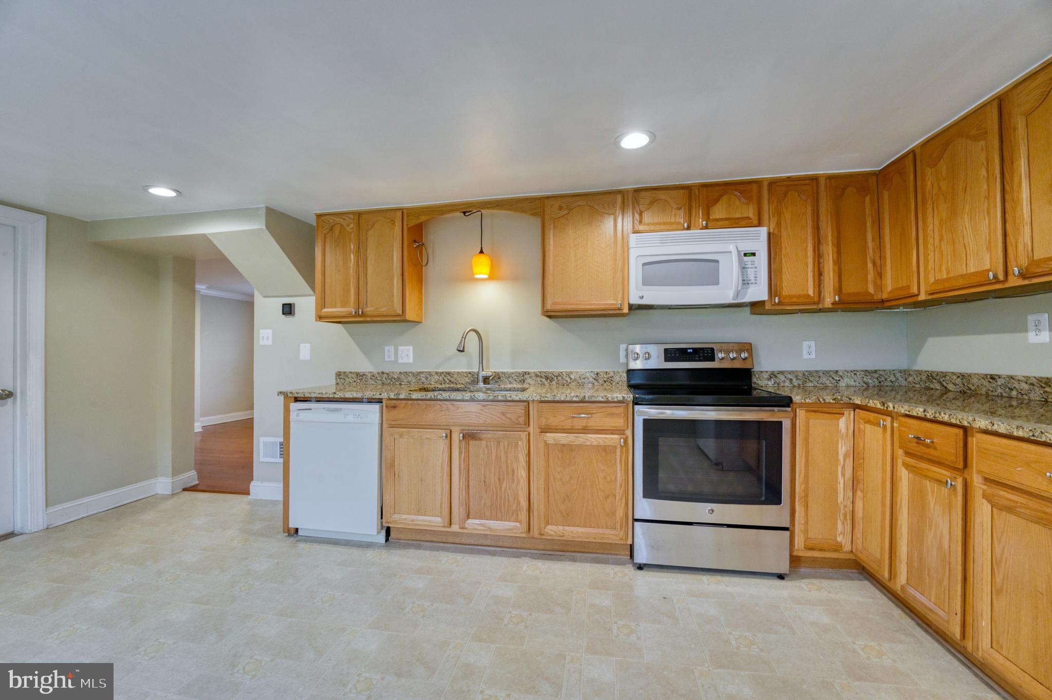 1080 Russell Road Berryville, VA 22611 - Photo 12 of 31 a kitchen with granite countertop a sink and cabinets