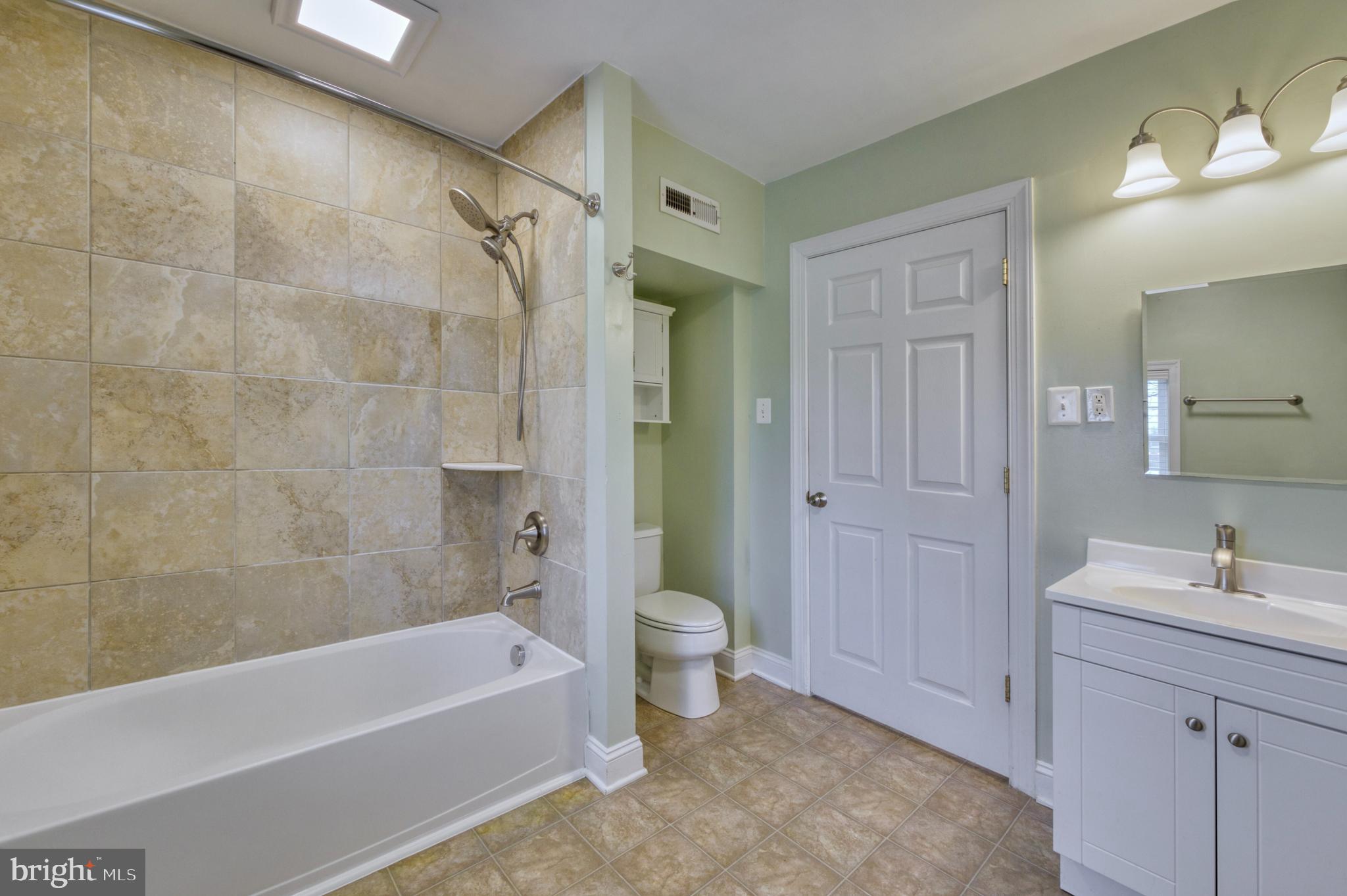 1080 Russell Road Berryville, VA 22611 - Photo 14 of 31 a bathroom with a bathtub shower sink vanity and a toilet