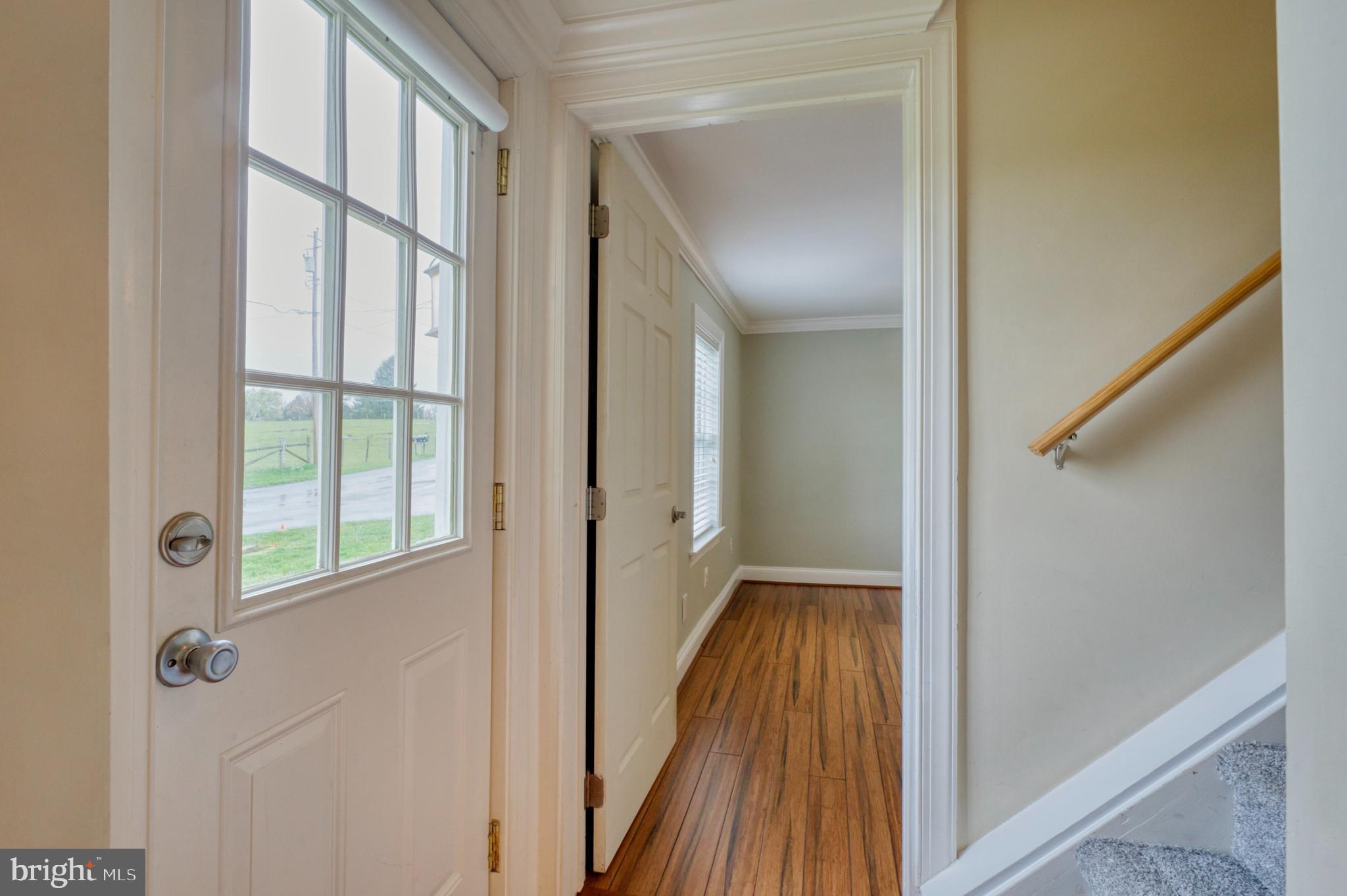 1080 Russell Road Berryville, VA 22611 - Photo 4 of 31 a view of a hallway with wooden floor and a bathroom