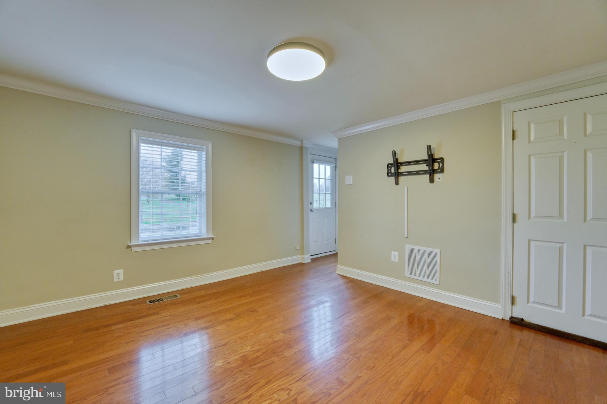 1080 Russell Road Berryville, VA 22611 - Photo 5 of 31 an empty room with wooden floor and windows