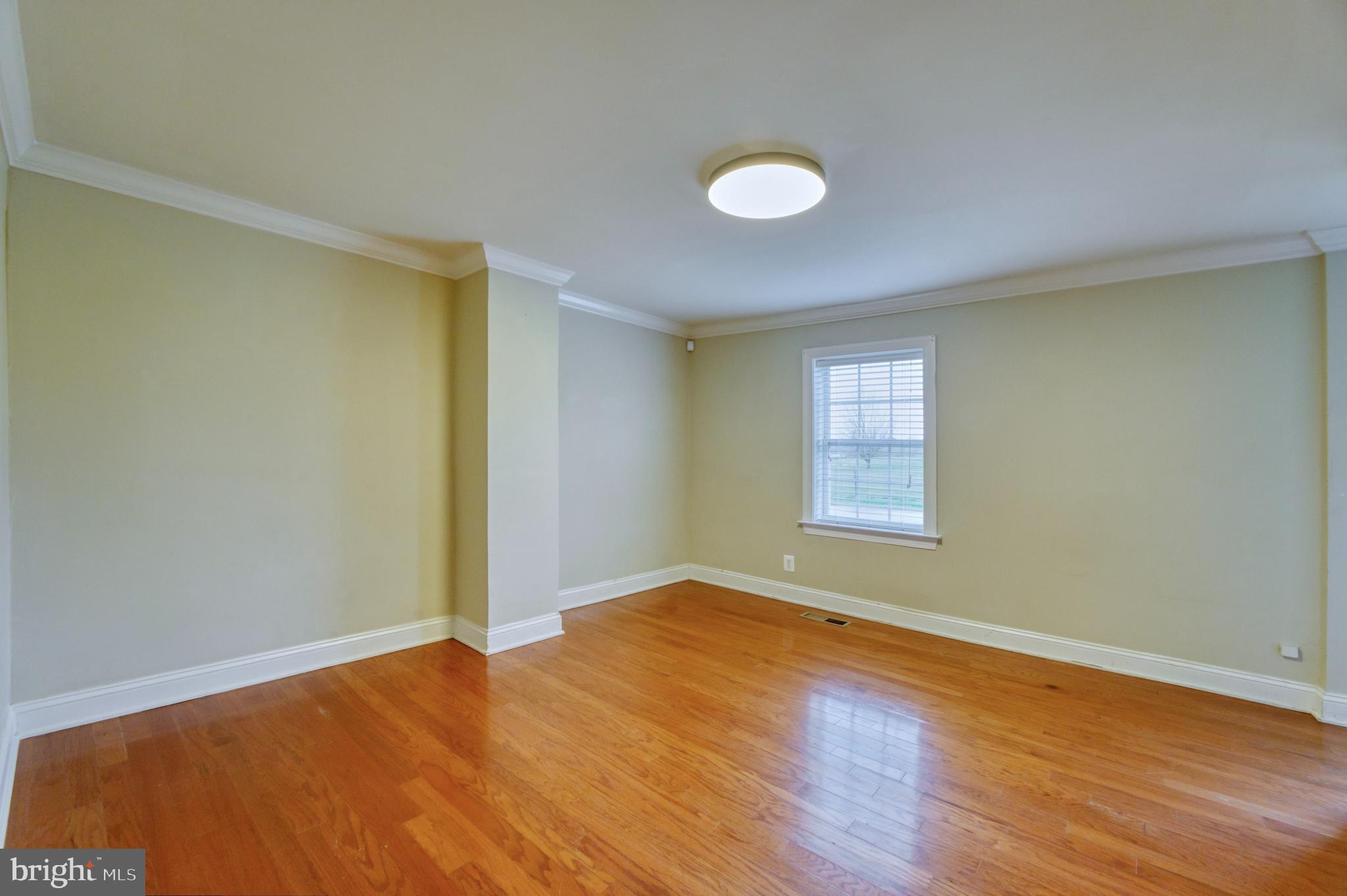 1080 Russell Road Berryville, VA 22611 - Photo 7 of 31 an empty room with wooden floor and windows