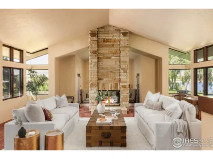 a dining room with furniture a chandelier and wooden floor