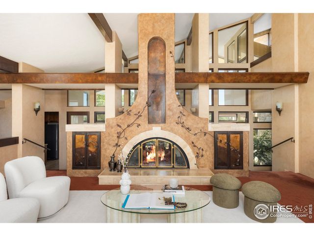 a view of a patio with a dining table and chairs with a fire pit