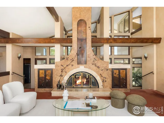 a view of a patio with a dining table and chairs with a fire pit