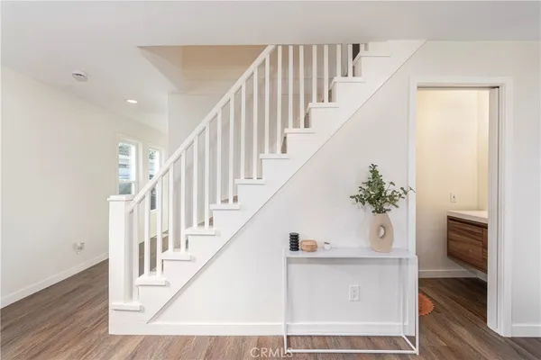 a view of entryway and hall with wooden floor