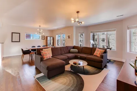 a living room with furniture and a chandelier