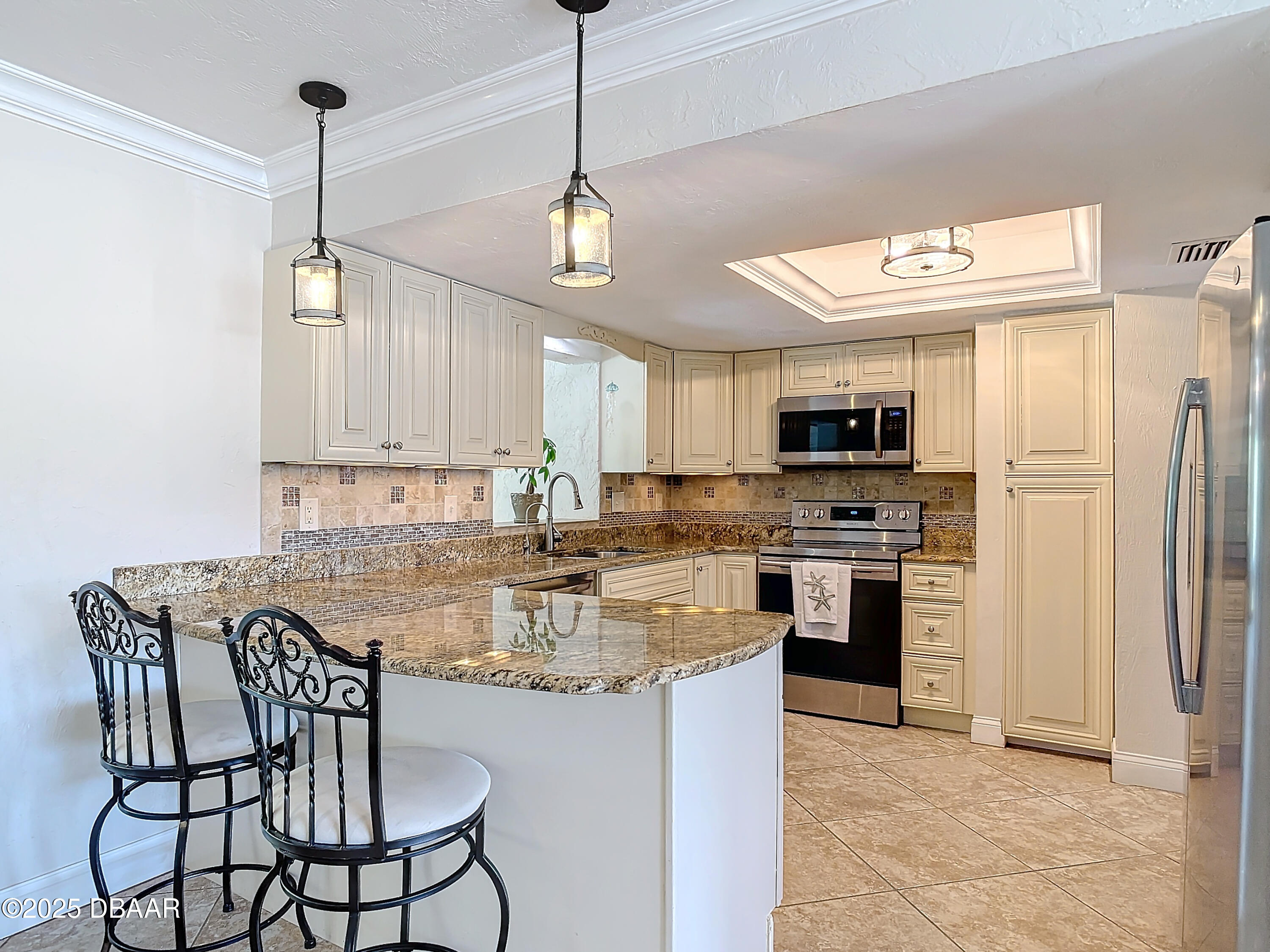 86 Rains Court Ponce Inlet, FL 32127 - Photo 18 of 71 a kitchen with stainless steel appliances granite countertop a stove a refrigerator a kitchen island a sink white cabinets and chairs